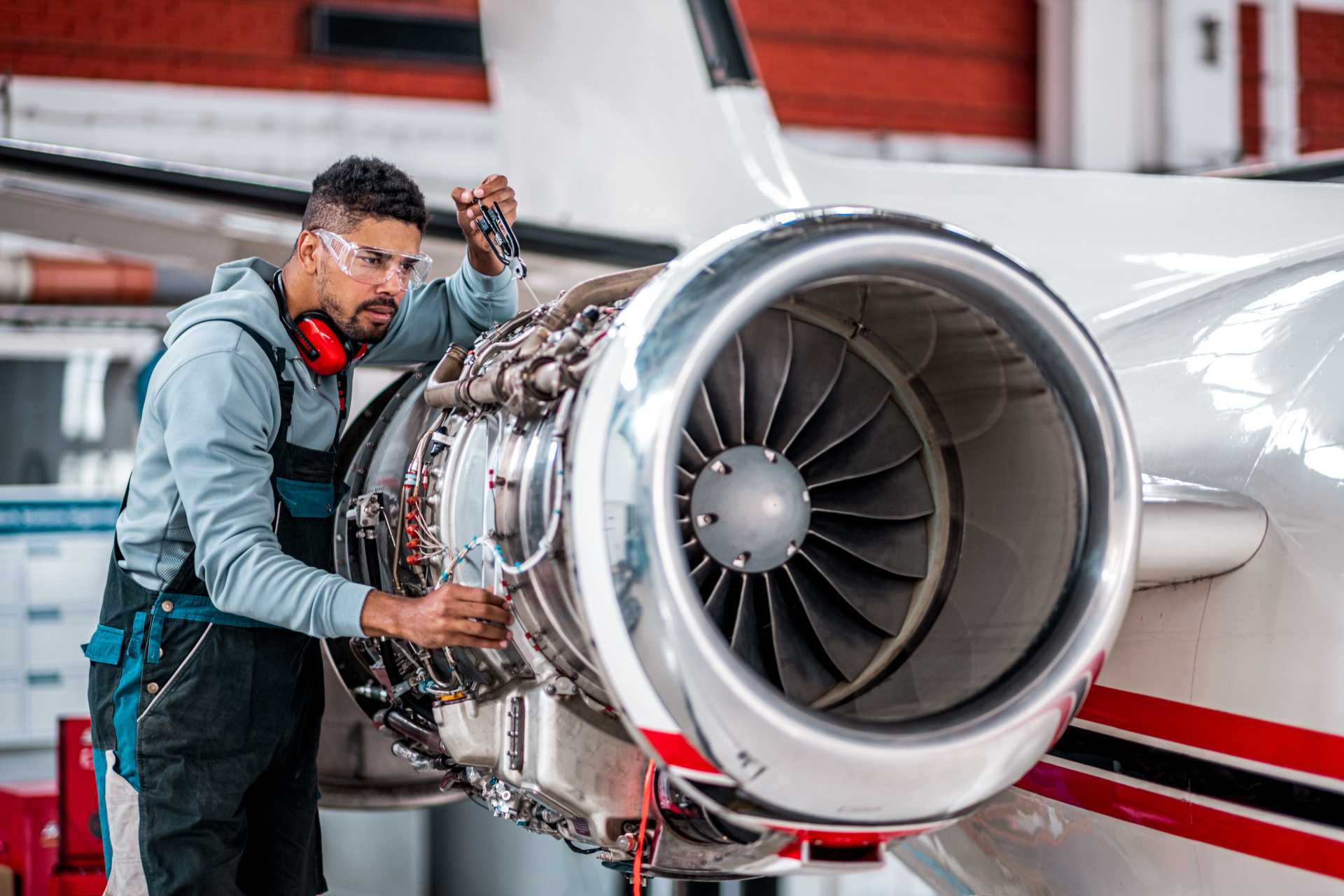 man-working-turbine-of-jet